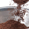 Close-up of fine coffee grounds falling into a stainless steel micro filter with the Aerolatte logo, designed for manual pour-over brewing in Kitchen & Food and Brewing Coffee collections.