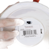 Close-up of a handcrafted dolomite bell’s underside showing a battery-operated switch and product label, highlighting its unique design for Home & Decor, Holiday Decor, and Promo Eligible collections.