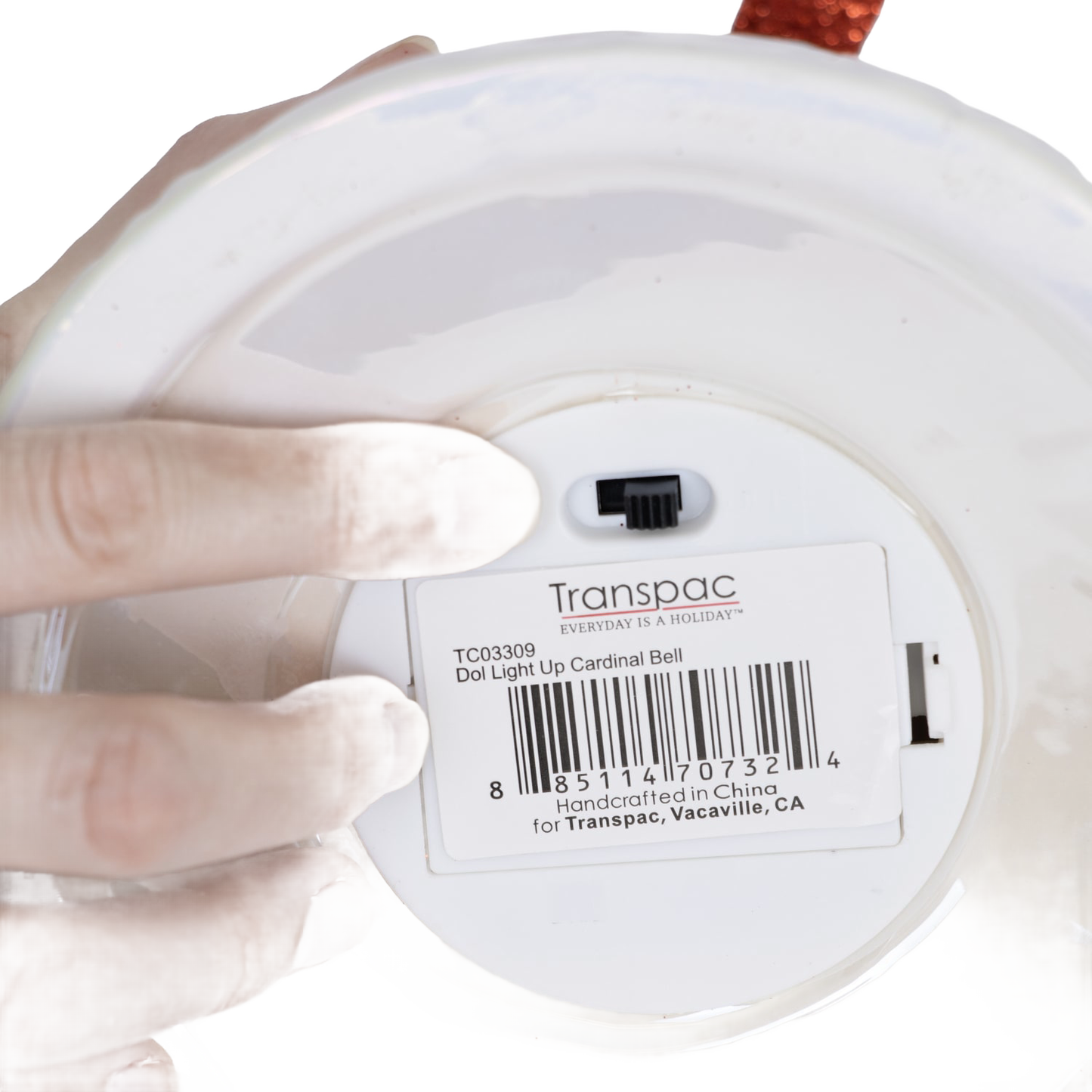 Close-up of a handcrafted dolomite bell’s underside showing a battery-operated switch and product label, highlighting its unique design for Home & Decor, Holiday Decor, and Promo Eligible collections.