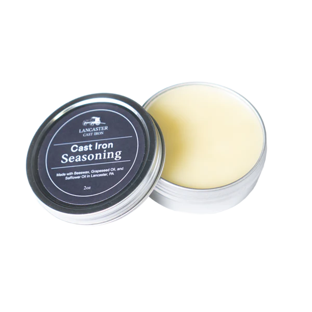 Open metal tin of handcrafted cast iron seasoning balm made with beeswax, grapeseed, and safflower oils, ideal for maintaining cookware in Kitchen & Food, Cast Iron, and USA Made collections.