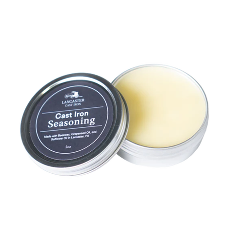 Open metal tin of handcrafted cast iron seasoning balm made with beeswax, grapeseed, and safflower oils, ideal for maintaining cookware in Kitchen & Food, Cast Iron, and USA Made collections.