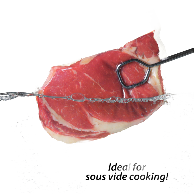 Raw marbled beef steak vacuum-sealed in a clear plastic bag with a metal meat fork, demonstrating food preservation for Kitchen & Food, Food Preservation, and Freezing collections.