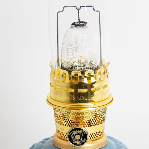 Close-up of a handcrafted aluminum alloy burner with polished brass components and a clear textured chimney, featured in Lamps & Lighting, Oil Lamps, Table Lamps, Best Sellers, and Promo Eligible collections.