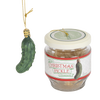 Green Christmas pickle ornament hanging by gold string next to a clear glass jar with a cream lid and label, part of holiday decor, home & decor, and best sellers collections