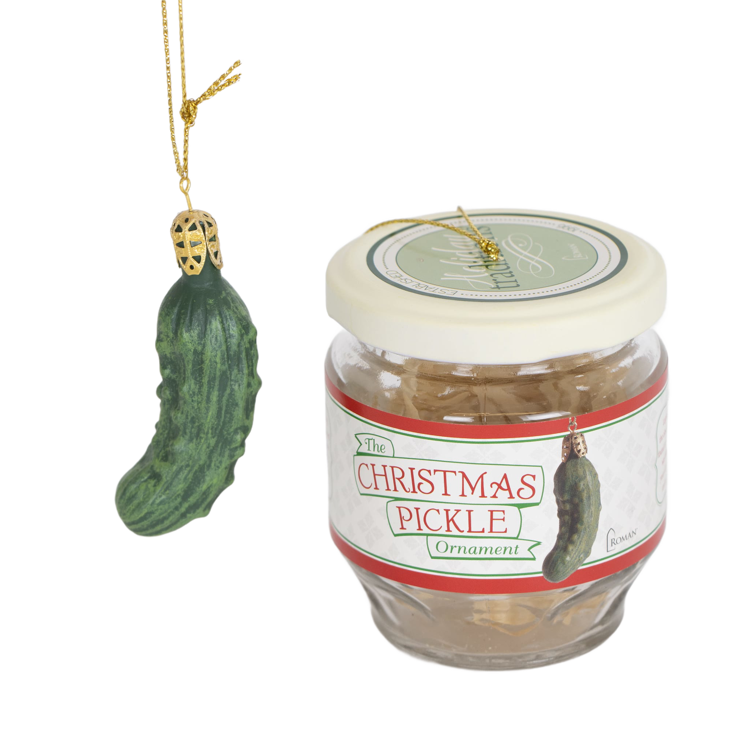 Green Christmas pickle ornament hanging by gold string next to a clear glass jar with a cream lid and label, part of holiday decor, home & decor, and best sellers collections
