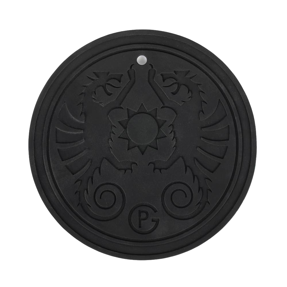 Black round silicone coaster with embossed twin griffin design and a central sun motif, temperature resistant and featuring a hanging eyelet, ideal for camping and lighting accessories.
