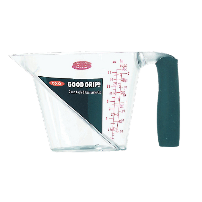 Clear plastic measuring cup with angled red measurement markings, textured black soft grip handle, designed for easy reading from above, featured in Kitchen & Food and Measuring collections.