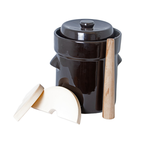 Dark ceramic fermentation crock with lid and light-colored dual-sided wooden stomper designed for tamping food in small crocks and jars, featured in Kitchen & Food and Food Preservation collections.