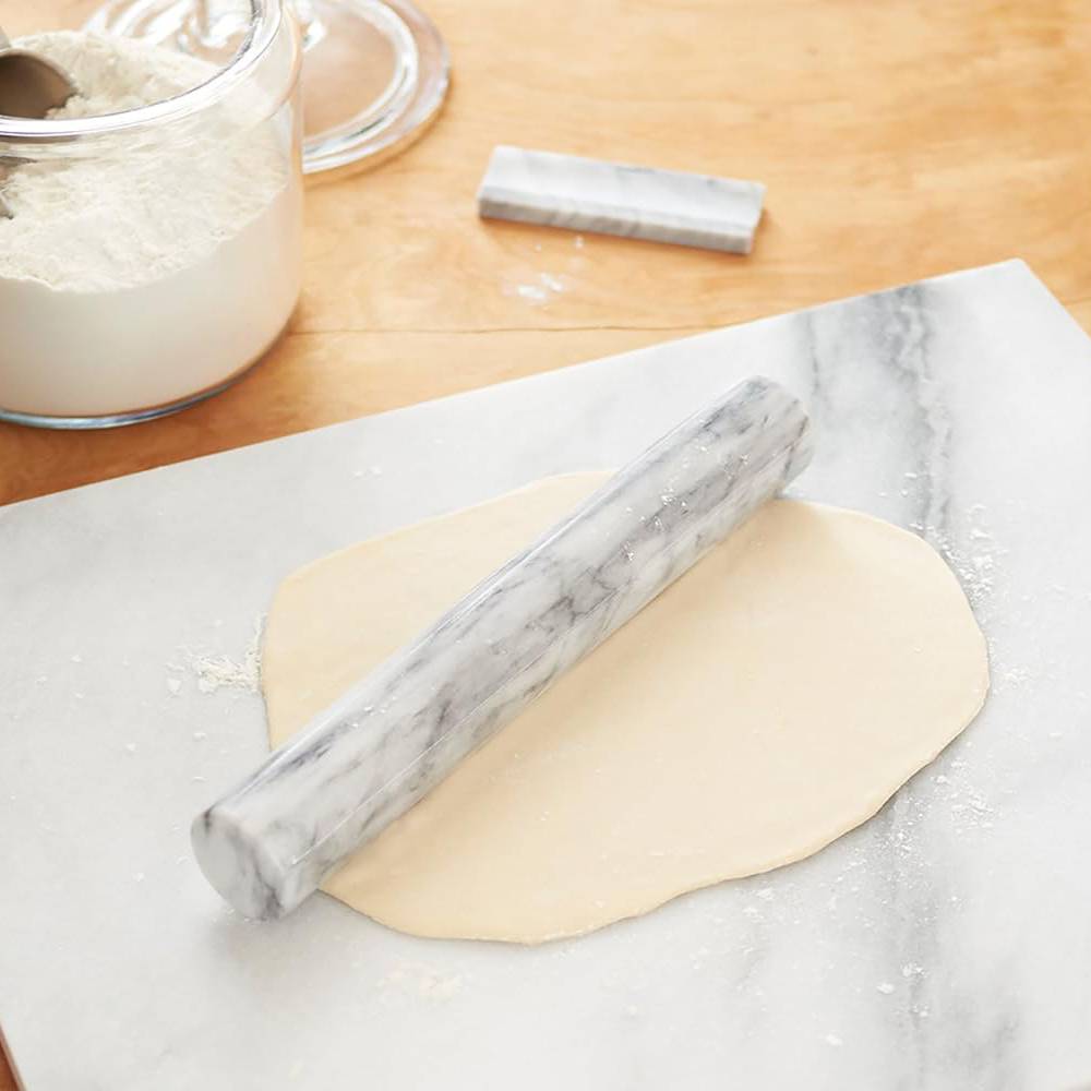 Marble French rolling pin with stand shown rolling dough on a marble board, highlighting its natural non-stick and stay-cool properties, featured in Kitchen & Food and Baking Supplies collections.