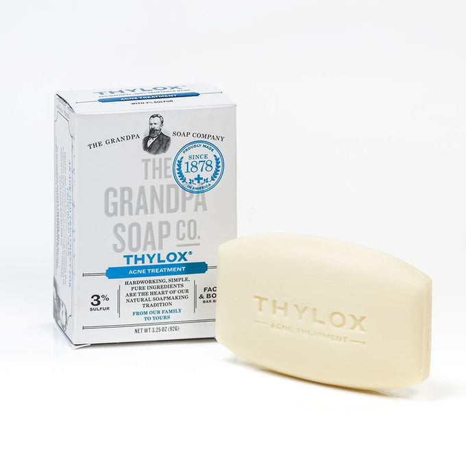 Bar of handcrafted acne treatment soap with 3% sulfur beside white box featuring blue accents, made in USA and included in Health & Wellness, Grooming, and Soaps collections.