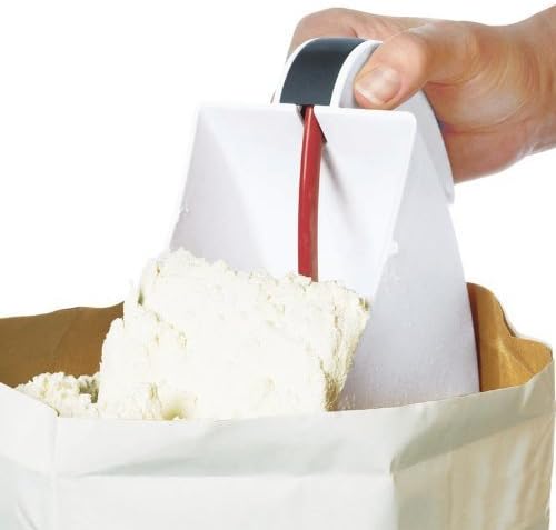 Hand pressing trigger on white plastic flour scoop and sifter lifting flour from paper bag, designed for clump-free baking, suitable for Kitchen & Food, Cookware, and Baking Supplies collections.