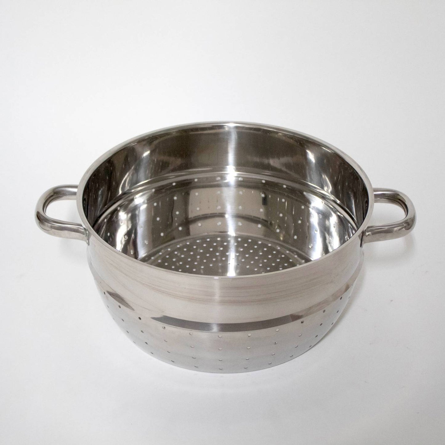 Polished stainless steel perforated fruit basket insert with side handles, designed for stovetop use in Kitchen & Food, Juicers and Steamers, Best Sellers, and Promo Eligible collections.