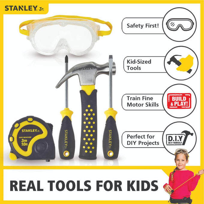 Child-sized 5-piece toolset with real hammer, Phillips and flat screwdrivers, 10-foot tape measure, and clear safety goggles with yellow and black rubber grips, designed for indoor play and DIY projects.