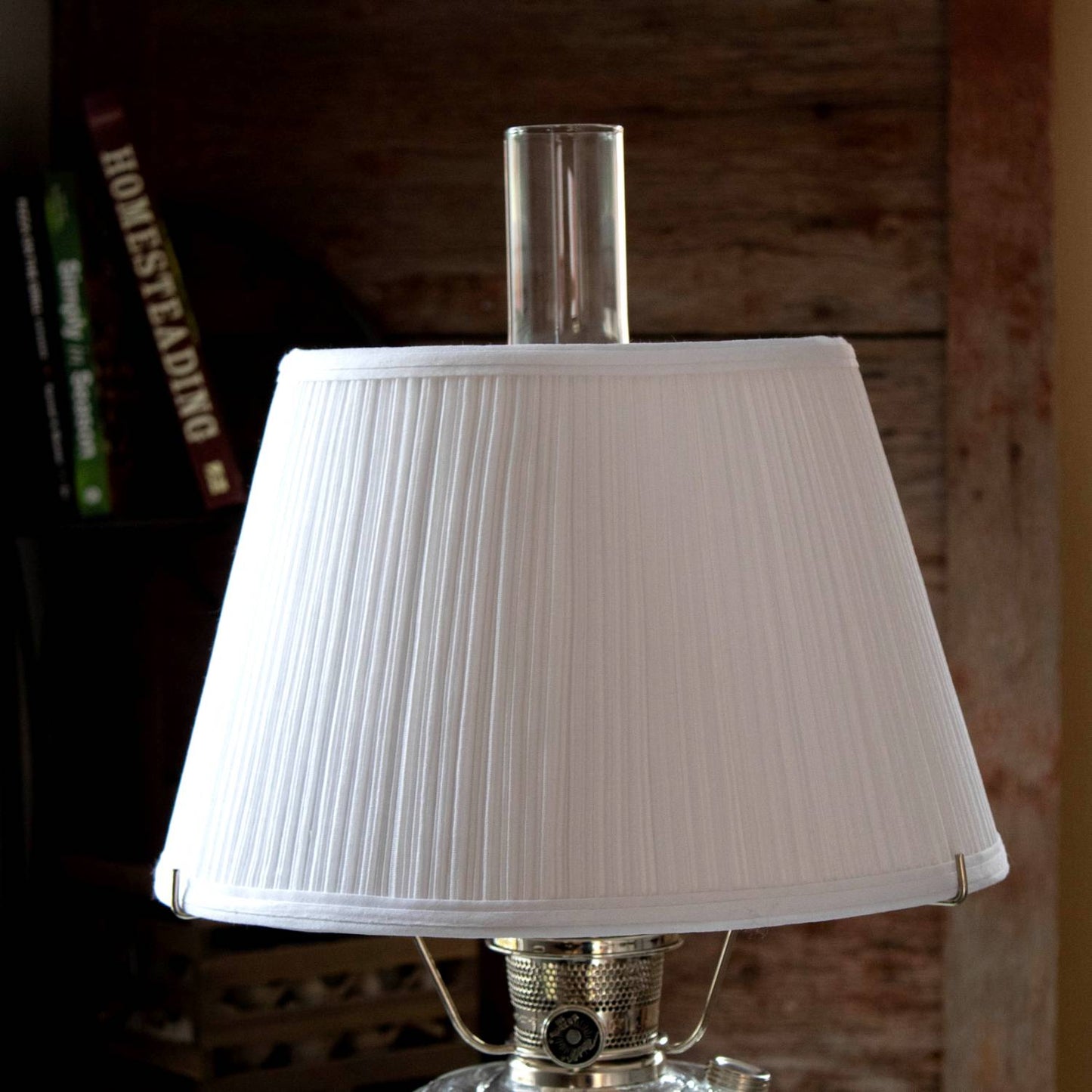 White cloth pleated oil lamp shade softening light from an Aladdin lamp, crafted for durability and featured in Lamps & Lighting, Lamp Shades, and Parts and Accessories collections.