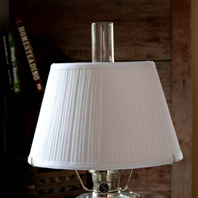 White cloth pleated oil lamp shade softening light from an Aladdin lamp, crafted for durability and featured in Lamps & Lighting, Lamp Shades, and Parts and Accessories collections.