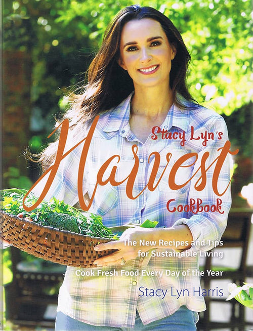 Smiling woman holding a woven basket filled with fresh greens outdoors, featured on the cover of a sustainable living cookbook in the Books, Cookbooks, Health and Wellness Books, and Best Sellers collections.