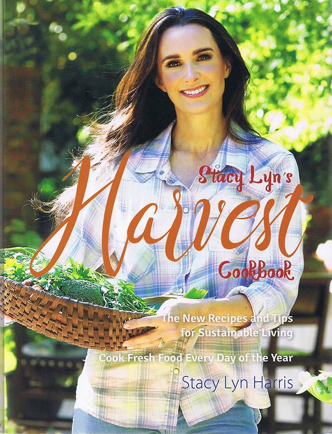 Smiling woman holding a woven basket filled with fresh greens outdoors, featured on the cover of a sustainable living cookbook in the Books, Cookbooks, Health and Wellness Books, and Best Sellers collections.