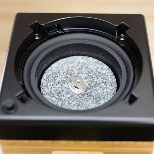 Close-up of the near diamond-hard corundum milling stone inside the NutriMill Harvest Electric Grain Mill, designed for versatile grinding in Kitchen & Food and Grain Mills collections.