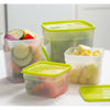 Set of durable plastic freezer storage containers in various sizes with green lids, filled with chopped vegetables and fruit, ideal for food preservation and kitchen storage collections.
