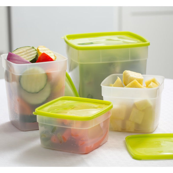 Set of durable plastic freezer storage containers in various sizes with green lids, filled with chopped vegetables and fruit, ideal for food preservation and kitchen storage collections.