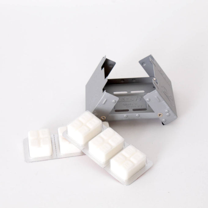 Compact metal camping stove with folding sides shown alongside four white fuel tablets in blister packs, designed for outdoor use in Farm, Garden & Tool and Camping collections.