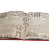 Open hardcover book with vintage-style illustrations and ornate lettering featuring Santa Claus and holiday-themed text, highlighting a charming holiday decor and children's book collection.
