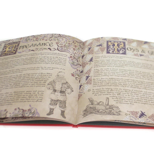 Open hardcover book with vintage-style illustrations and ornate lettering featuring Santa Claus and holiday-themed text, highlighting a charming holiday decor and children's book collection.