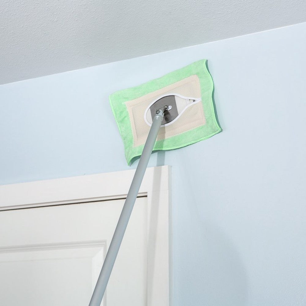 Long-handled cleaning mop with a green washable flat head reaching high on a light blue wall above a white door, showcasing a handcrafted Amish-made cleaning tool from USA collections.