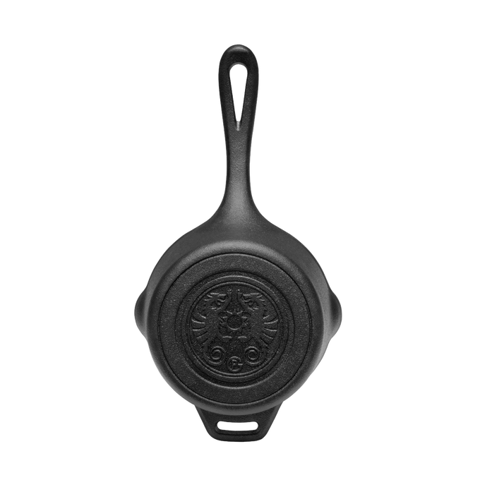 Heavy-duty cast iron saucepan with lid and embossed self-basting design on bottom, featuring an extended handle, perfect for camping, farm, garden, and outdoor cookware collections.