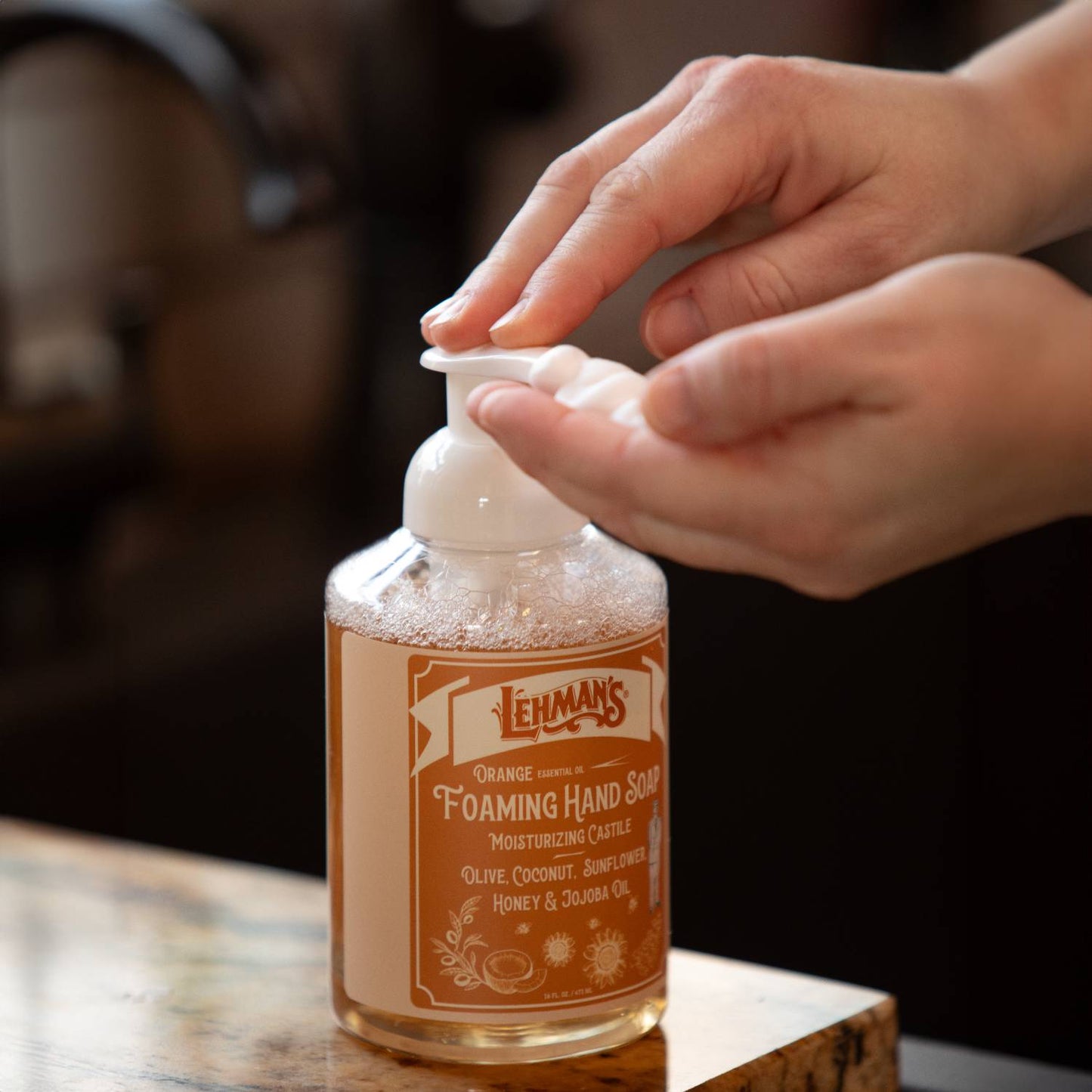 Person dispensing handcrafted Lehman's foaming hand soap with moisturizing natural oils including olive, coconut, sunflower, honey, and jojoba, made in USA, ideal for Health & Wellness and Grooming collections.