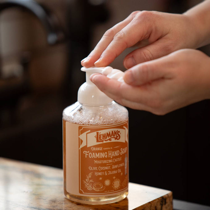 Person dispensing handcrafted Lehman's foaming hand soap with moisturizing natural oils including olive, coconut, sunflower, honey, and jojoba, made in USA, ideal for Health & Wellness and Grooming collections.