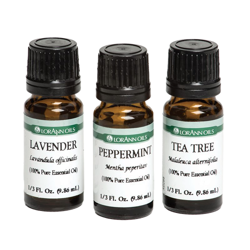 Three amber glass bottles of pure essential oils labeled lavender, peppermint, and tea tree, designed for aromatherapy, health remedies, and crafting uses.