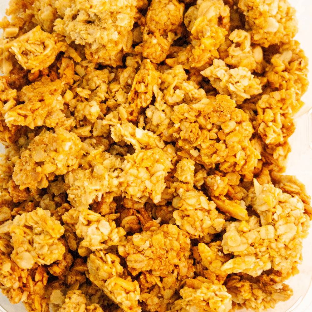 Close-up view of crunchy granola clusters with peanut butter pieces, featuring a golden-brown color and hearty texture, ideal for Pantry, Kitchen & Food, and USA Made collections.
