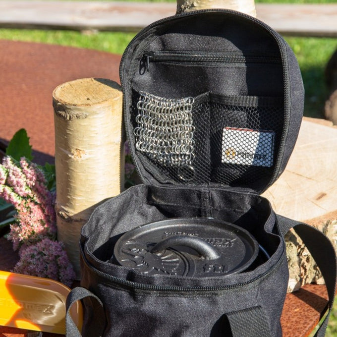 Black ripstop fabric bag unzipped to reveal a cast iron Dutch oven inside and mesh pockets holding small accessories, suitable for Farm, Garden & Tool, Camping, and Best Sellers collections.