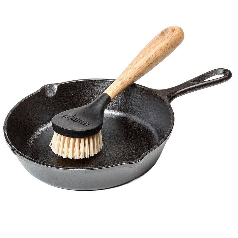 Scrubbing brush with stiff nylon bristles and an ergonomic rubberwood handle resting in a seasoned cast iron skillet, ideal for Kitchen & Food, Cookware, Cast Iron, Best Sellers, and Promo Eligible collections.