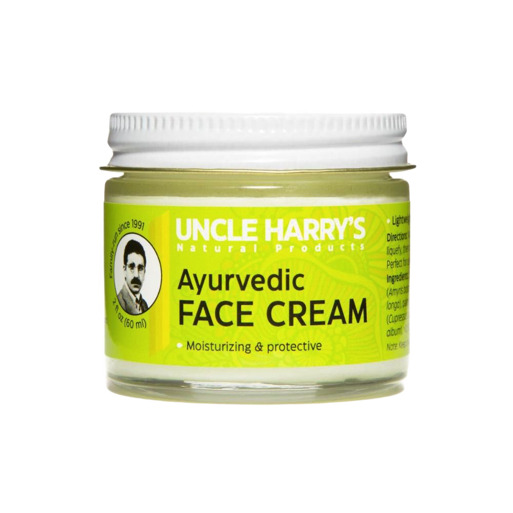 Small glass jar of handcrafted Ayurvedic face cream featuring moisturizing jojoba esters and soothing turmeric and sandalwood oils, made in USA for health and wellness.