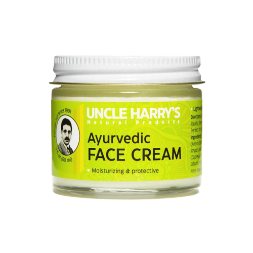 Small glass jar of handcrafted Ayurvedic face cream featuring moisturizing jojoba esters and soothing turmeric and sandalwood oils, made in USA for health and wellness.