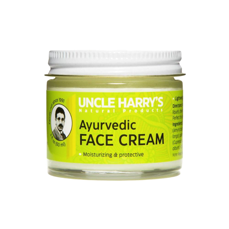 Small glass jar of handcrafted Ayurvedic face cream featuring moisturizing jojoba esters and soothing turmeric and sandalwood oils, made in USA for health and wellness.