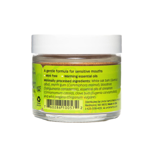 Clear jar of handcrafted tooth powder with white lid showing label that highlights a gentle, mint-free formula with warming essential oils, made in USA, suitable for health remedies, grooming, and wellness collections.