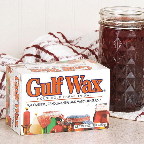 Box of Original Gulf Wax household paraffin wax next to a glass jar of preserved food on a kitchen counter, highlighting its use for canning, candlemaking, and food preservation in USA made collections.