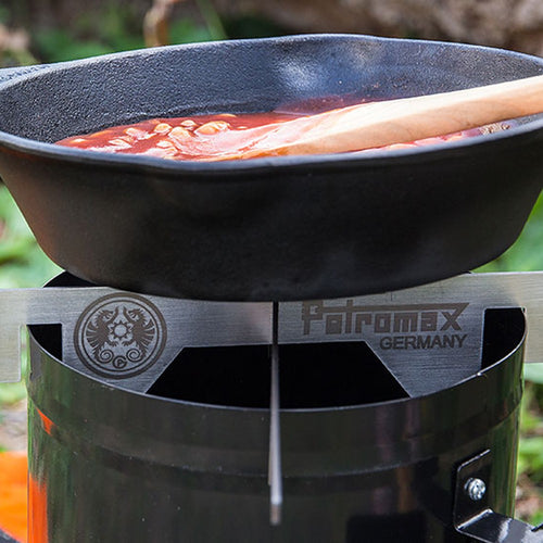 Handcrafted stainless steel fire stand providing stable heat support for outdoor cooking with a cast iron skillet, ideal for Farm, Garden & Tool, Camping, Best Sellers, and Promo Eligible collections.