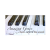 Scenic deluxe magnet featuring a close-up of black and white piano keys with the inspiring verse "Amazing Grace ... how sweet the sound," perfect for Home & Decor and Best Sellers collections.