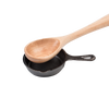 Wooden spoon resting inside a small pre-seasoned cast iron skillet, showcasing classic kitchen tools ideal for cookware, cast iron, and kitchen accessories collections.