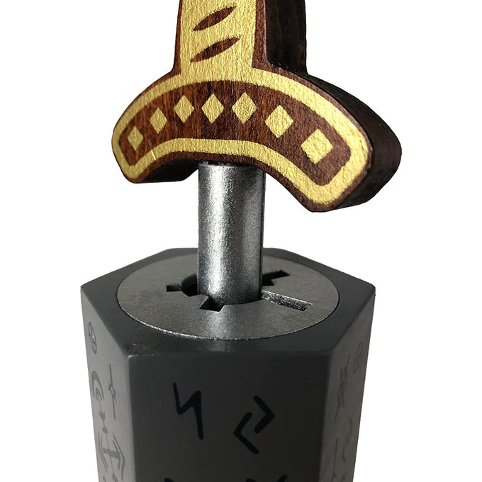 Handcrafted wooden brainteaser puzzle featuring a decorated sword hilt inserted into a stone base with ancient symbols, perfect for Toys, Books & Games and Puzzles collections.
