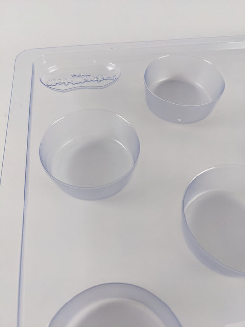 Clear plastic round soap mold with multiple cavities for creating 2.5 oz bars, designed for soapmaking enthusiasts and included in Health & Wellness and USA Made collections.