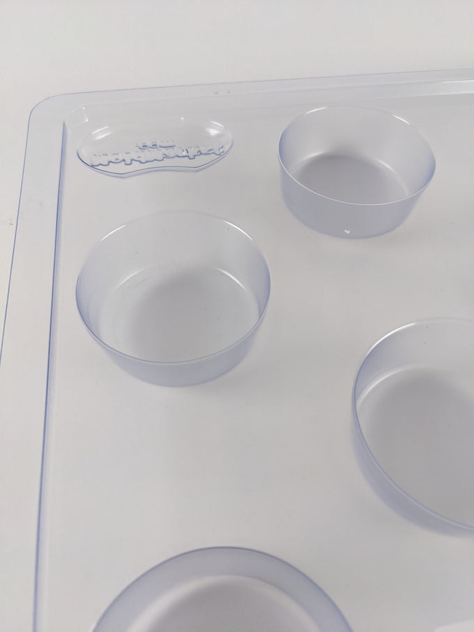 Clear plastic round soap mold with multiple cavities for creating 2.5 oz bars, designed for soapmaking enthusiasts and included in Health & Wellness and USA Made collections.