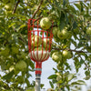 Red enameled steel picking basket attached to a telescoping aluminum pole collecting fresh green apples from a tree, part of Farm, Garden & Tool and Apple Harvest Supplies collections.