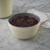 Cream-colored Mason Cash all-purpose bowl filled with a traditional steamed pudding, styled on a marble surface with a rustic twine-tied cloth, ideal for Kitchen & Food, Cookware, Baking Supplies, Storage and Serving, Best Sellers, and Promo Eligible collections.