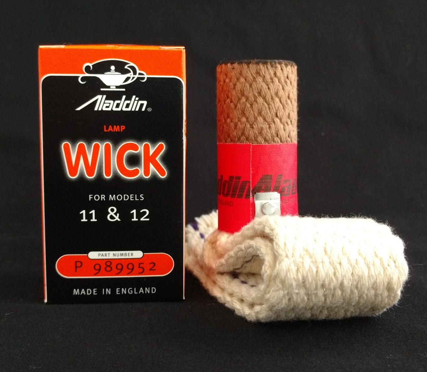 Vintage-style oil lamp wick with red label and metal clamp, displayed next to its original box indicating compatibility with models 11 and 12, part of lamps and lighting accessories, best sellers, and promo eligible collections, handcrafted quality.