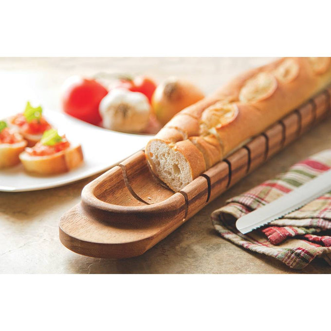 Handcrafted acacia hardwood baguette miter with grooves for perfectly slicing large loaves, shown on a kitchen surface with sliced bread, tomatoes, and garlic, ideal for Kitchen & Food and Food Prep collections.